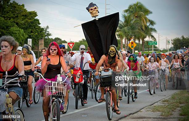 Participants take part in the zombie bike ride on the A1A next to the Atlantic Ocean on October 20, 2013 in Key West, Florida. Thousands of costumed...