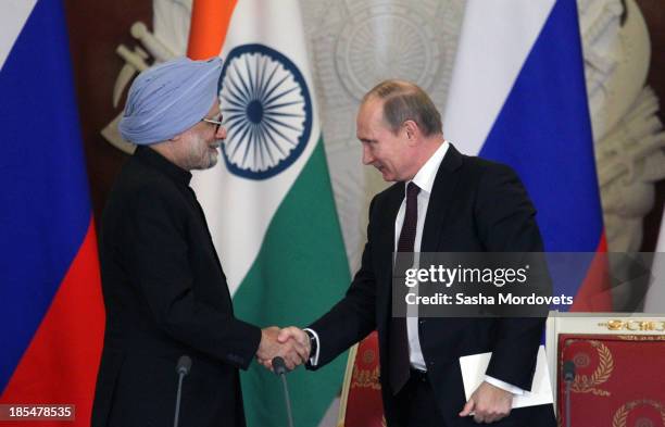 Russian President Vladimir Putin shakes hands with Indian Prime Minister Manmohan Singh during their bilateral meeting in the Kremlin on October 21,...