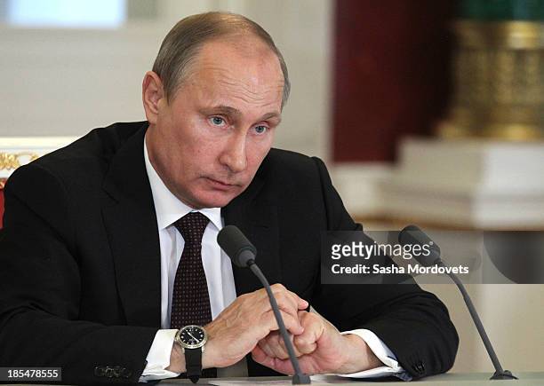 Russian President Vladimir Putin attends a meeting with Indian Prime Minister Manmohan Singh in the Kremlin on October 21, 2013 in Moscow, Russia,...