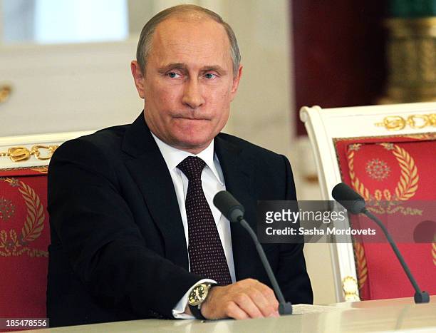 Russian President Vladimir Putin attends a meeting with Indian Prime Minister Manmohan Singh in the Kremlin on October 21, 2013 in Moscow, Russia,...