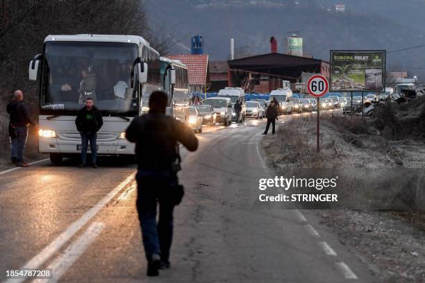 Buses and cars with Kosovo Serbs queue outside the town of Leposavic, northern Kosovo, bordering Serbia, on December 17 during parliamentary and...