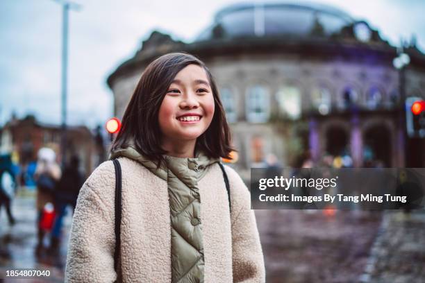 cheerful teenage girl walking in the street while exploring in a town - road signal stock pictures, royalty-free photos & images