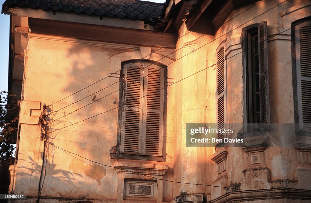 The flaking facade of an old French colonial building in...
