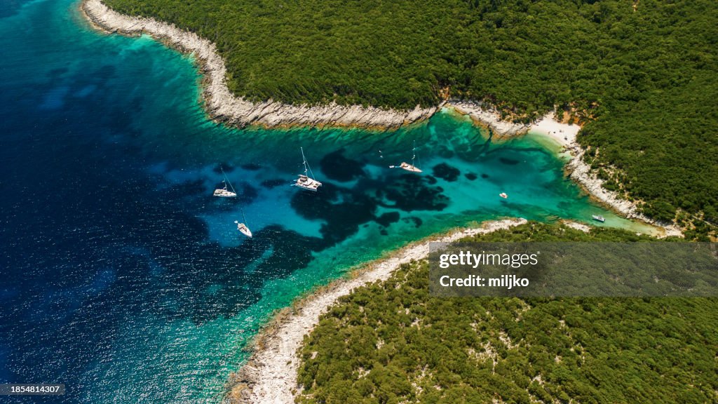 Sailboats anchored in a beautiful isolated bay in North Kefalonia, Greece