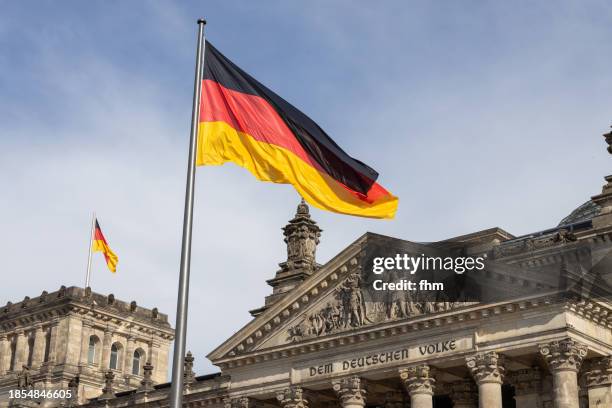 deutscher bundestag - reichstag building with german flags (german parliament building) - berlin, germany - german flag wallpaper stock pictures, royalty-free photos & images