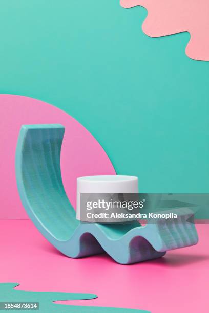 colorful 3d stage with white cosmetics jar on  pastel pink table with abstract geometric figures on turquoise mint green background. - pastel colored stock-fotos und bilder