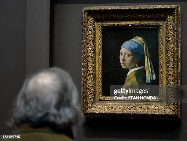 Man views "Girl with a Pearl Earring " by Johannes Vermeer in the exhibition "Vermeer, Rembrandt, and Hals: Masterpieces of Dutch Painting from the...