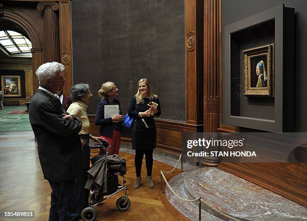 People view "Girl with a Pearl Earring " by Johannes Vermeer in the exhibition "Vermeer, Rembrandt, and Hals: Masterpieces of Dutch Painting from the...