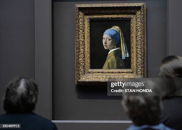 People view "Girl with a Pearl Earring " by Johannes Vermeer in the exhibition "Vermeer, Rembrandt, and Hals: Masterpieces of Dutch Painting from the...