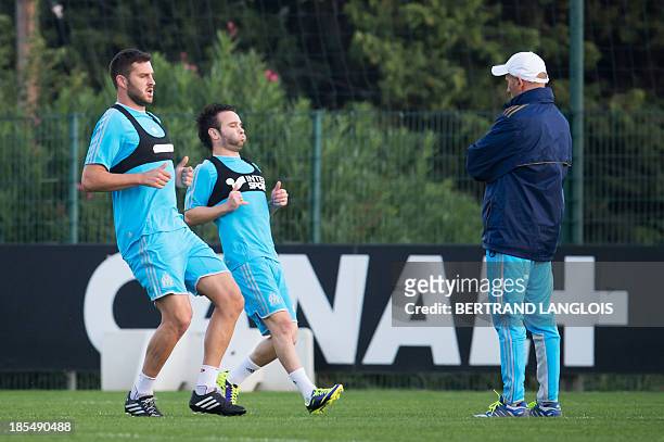 Marseille's French forward Andre-Pierre Gignac, French midfielder Mathieu Valbuena and French head coach Elie Baup take part in a training session on...