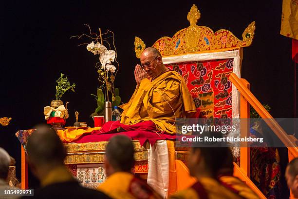 The Dalai Lama prays during an initiation ceremony at the Beacon Theater October 20, 2013 in New York City. The Dalai Lama is in New York City for...