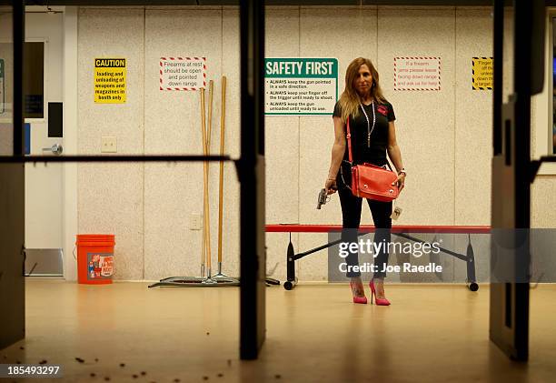 Susan Kushlin poses with a concealed-carry handbag that her company, Gun Girls, Inc., created for women that enjoy guns on October 21, 2013 in Boca...