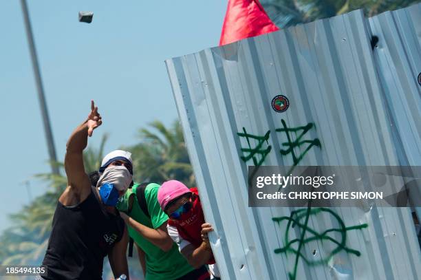 Activists protest in front of the hotel where Brazil's National Petroleum Agency auction drilling rights to one of the world's largest offshore oil...