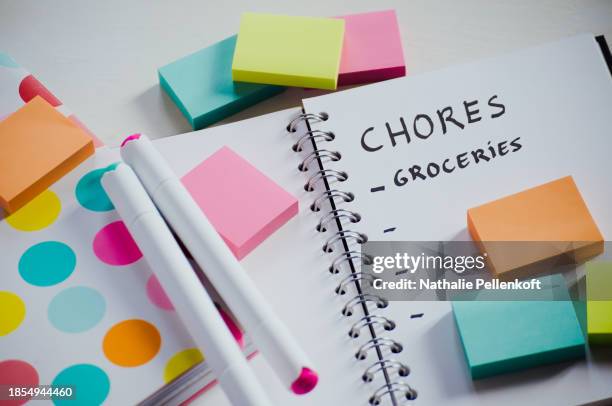 directly above shot of notebook with multi colored sticky notes on white table for organizing and productivity - nathalie pellenkoft stock pictures, royalty-free photos & images