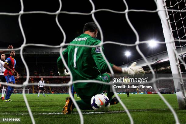 Philippe Senderos of Fulham squeezes the ball through the legs of goalkeeper Julian Speroni of Crystal Palace to score his team's fourth goal during...