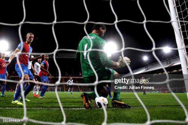 Philippe Senderos of Fulham squeezes the ball through the legs of goalkeeper Julian Speroni of Crystal Palace to score his team's fourth goal during...