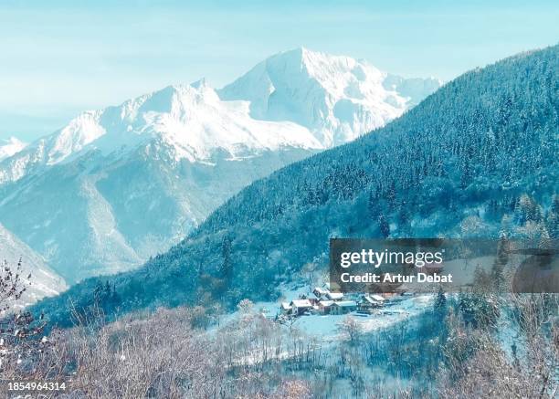 bucolic winter view of the snowy alps with rustic town and peak mountain. - meribel fotografías e imágenes de stock