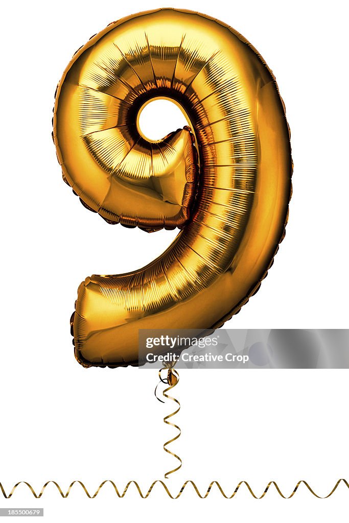 Gold balloon in the shape of a number nine