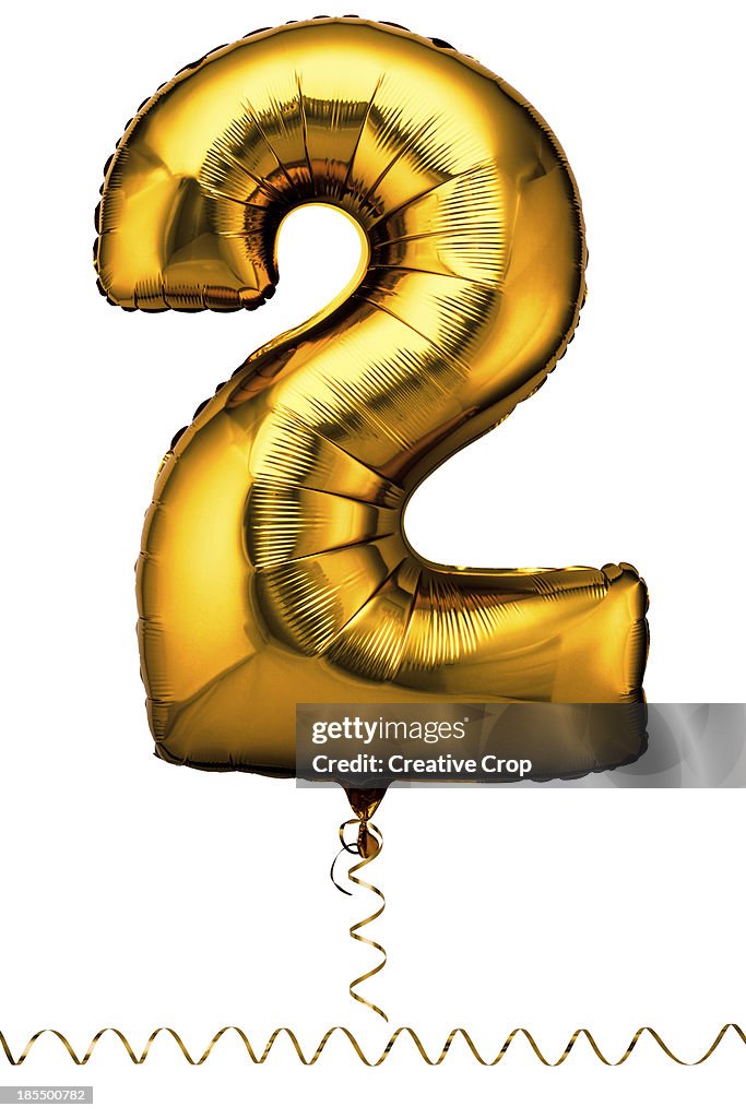 Gold balloon in the shape of a number two