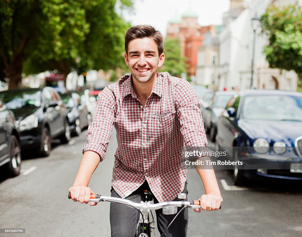 Man cycling down a street.