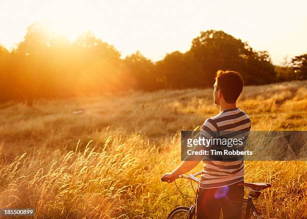 man on bike looking at view. - the end stock pictures, royalty-free photos & images