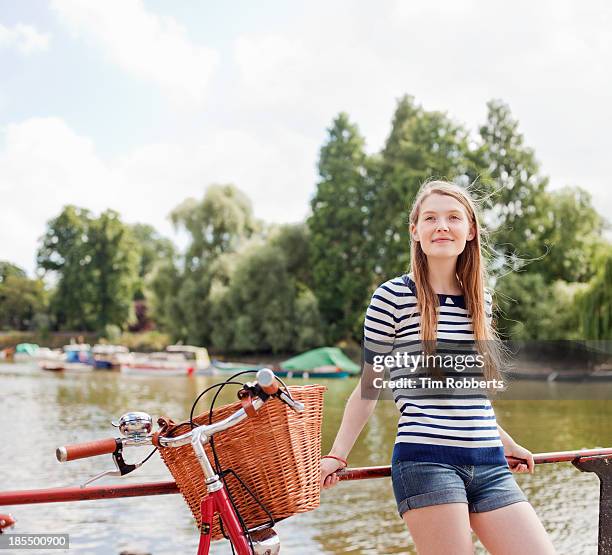 young woman relaxing next to bike - bicycle basket stock pictures, royalty-free photos & images