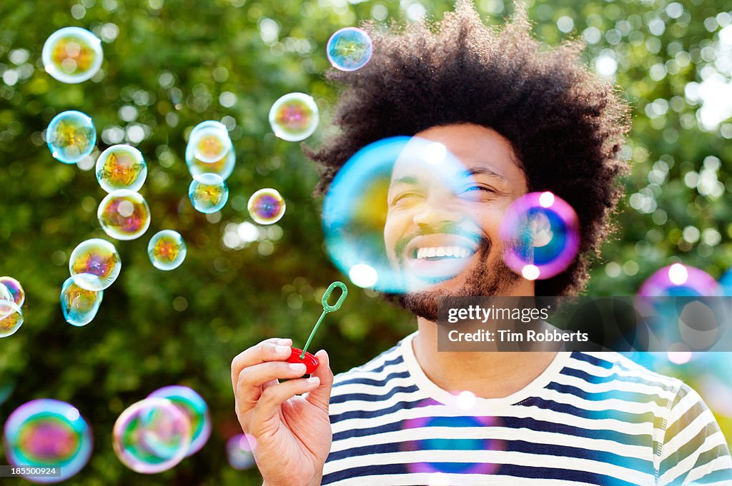 Man blowing bubbles.