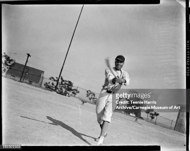 Schenley High School baseball player Charles Bundridge swinging bat on Schenley Field, Pittsburgh, Pennsylvania, 1941.