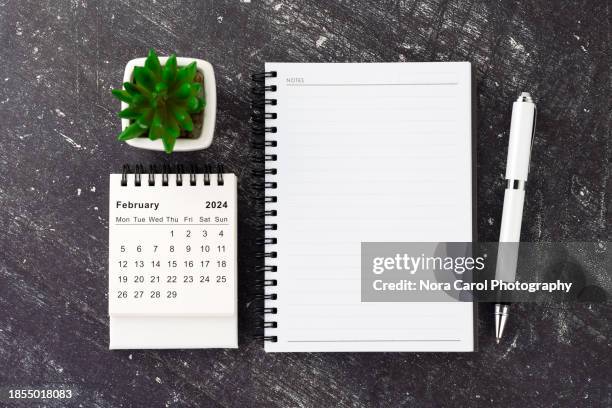 notepad and february 2024 calendar flat lay - desk calendar stock pictures, royalty-free photos & images