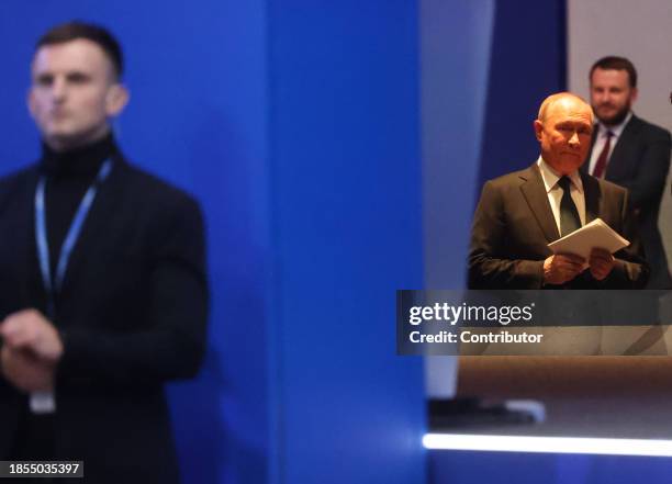 Russian President Vladimir Putin prepares to enter the scene during the 21th Congress of the United Russia Party, on December 17, 2023 in Moscow,...