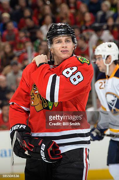 Patrick Kane of the Chicago Blackhawks adjusts his shoulder pad during the NHL game against the Buffalo Sabres on October 12, 2013 at the United...