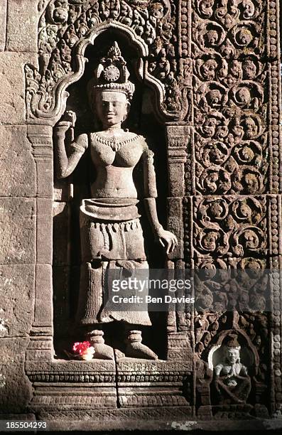 An intricate stone carving found in the ancient ruins of the Hindu Khmer temple of Wat Phu in Champassak Province, Laos. Historians claim that the...