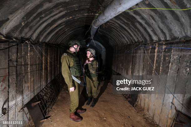 In this picture taken during a media tour organised by the Israeli military on December 15 soldiers visit a tunnel that Hamas reportedly used to...