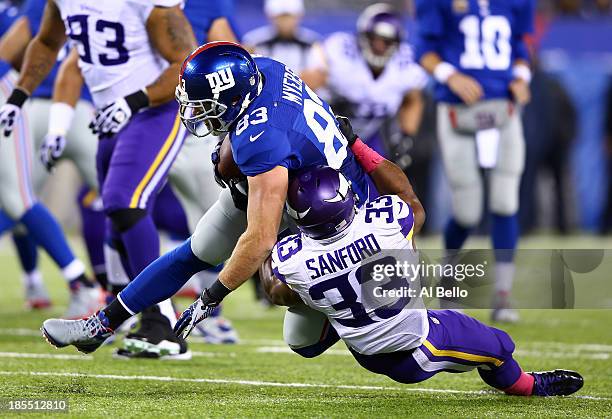 Strong safety Jamarca Sanford of the Minnesota Vikings tackles tight end Brandon Myers of the New York Giants during a game at MetLife Stadium on...