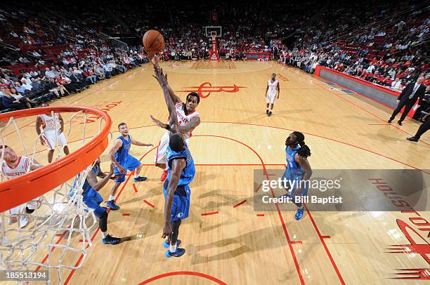 Greg Smith of the Houston Rockets shoots the ball against Bernard James of the Dallas Mavericks during a 2013 NBA pre-season game on October 21, 2013...