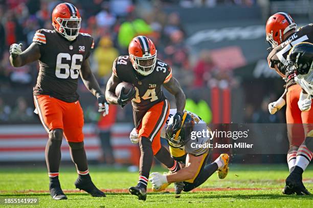 Running back Jerome Ford of the Cleveland Browns runs through a tackle by linebacker T.J. Watt of the Pittsburgh Steelers during the second quarter...