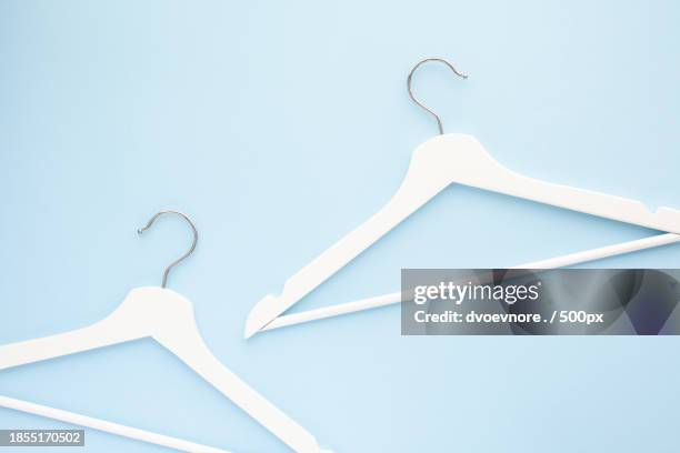 close-up of top hanging on coathanger against white background - editorial template stock pictures, royalty-free photos & images