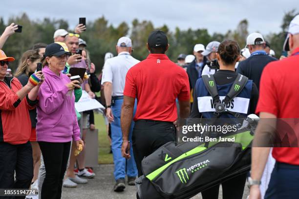 Tiger Woods and his daughter, Sam Woods, arrive to the golf course together during the final round of the PNC Championship at Ritz-Carlton Golf Club...