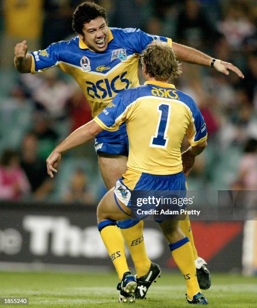 Nathan Cayless of the Eels celebrates with team mate Brett Hodgson after scoring the first try during round one of the 2003 NRL match between the...