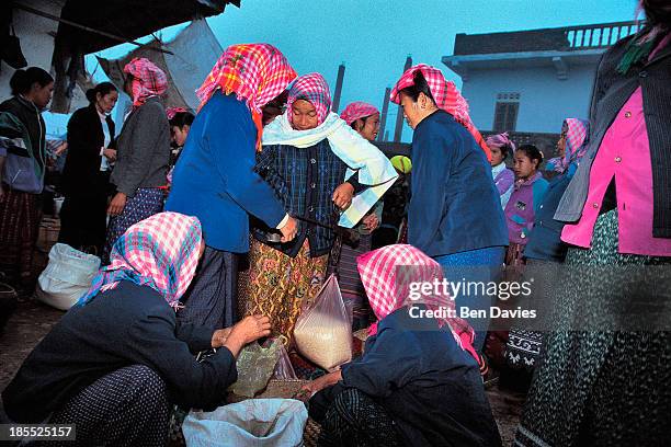 At dawn, ethnic minorities and hill tribes from the remote northern region of Luang Namtha Laos walk to the popular daily market of Talat Nyai in...