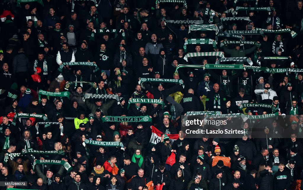 Fans of Ferencvarosi show their support as they hold scarves prior