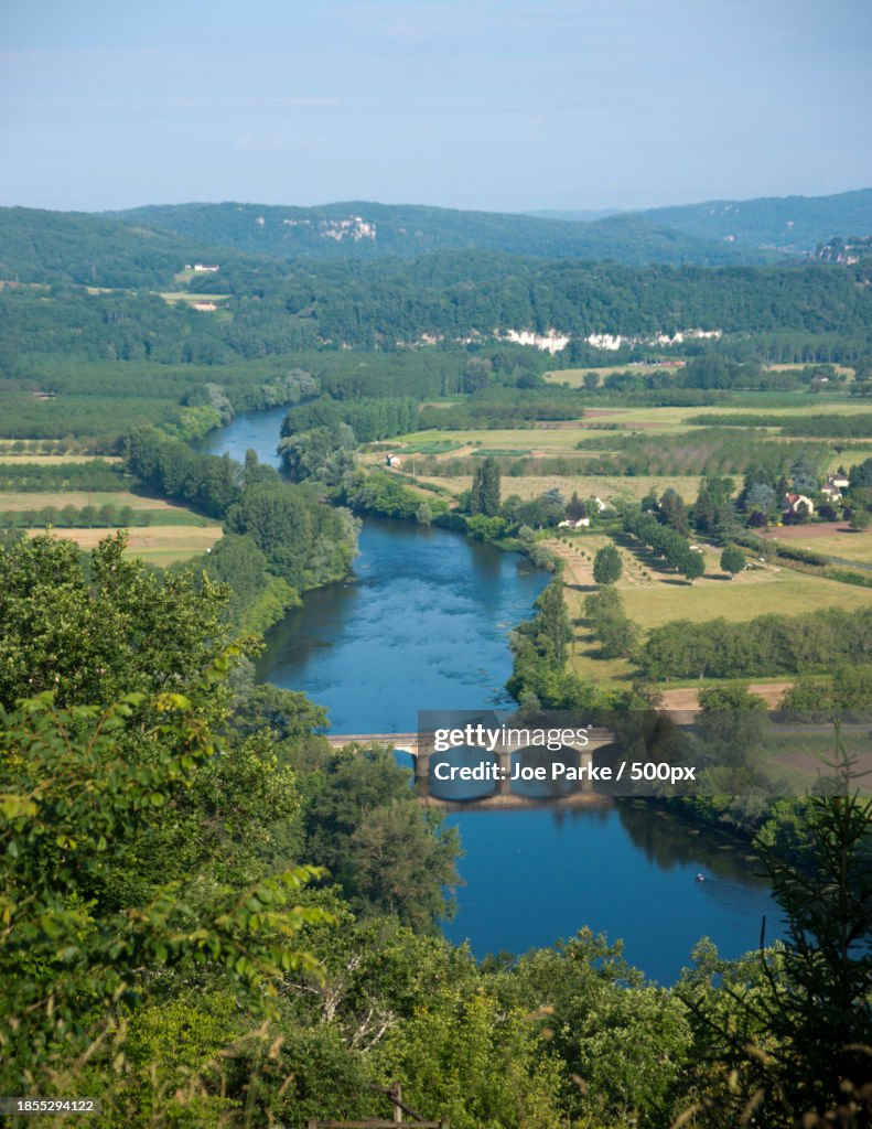 High angle view of river amidst trees against sky