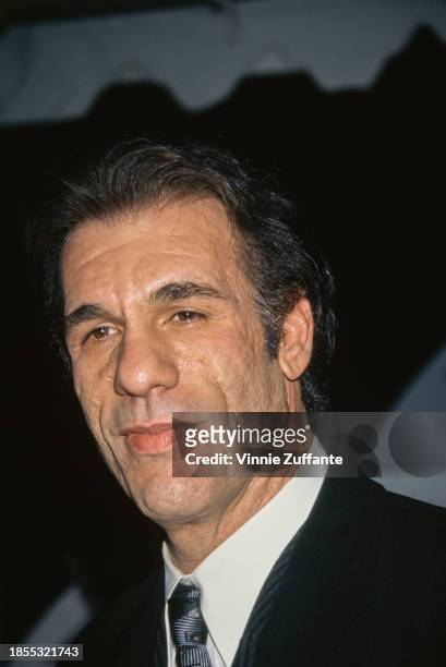 American actor and singer Robert Davi, wearing a suit with a shirt and tie, attends the 1997 NBC Affiliates Convention in Burbank, California, 11th...