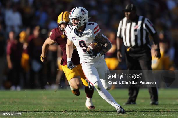 Wide receiver Jackson Holman of the Arizona Wildcats runs with the football during the second half of the NCAAF game at Mountain America Stadium on...