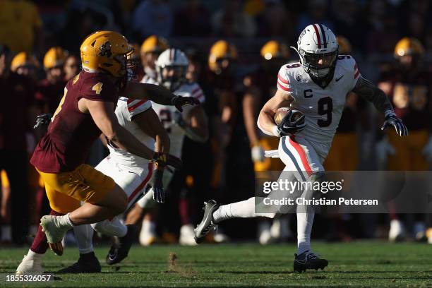 Wide receiver Jackson Holman of the Arizona Wildcats runs with the football during the second half of the NCAAF game at Mountain America Stadium on...