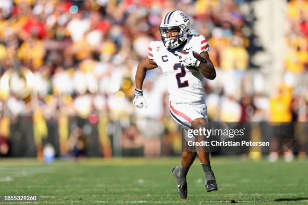 Ide receiver Jacob Cowing of the Arizona Wildcats runs with the football during the first half of the NCAAF game at Mountain America Stadium on...