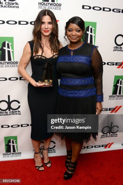 Actress Sandra Bullock poses with the Hollywood Actress Award for 'Gravity' next to actress Octavia Spencer in the press room during the 17th annual...