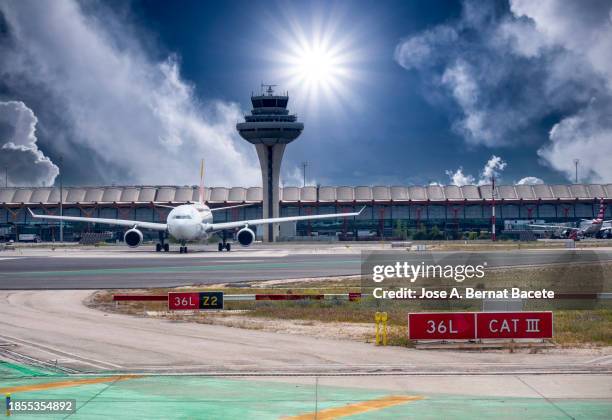 control tower and terminal of an airport with airplanes on the runway. - madrid barajas flygplats bildbanksfoton och bilder