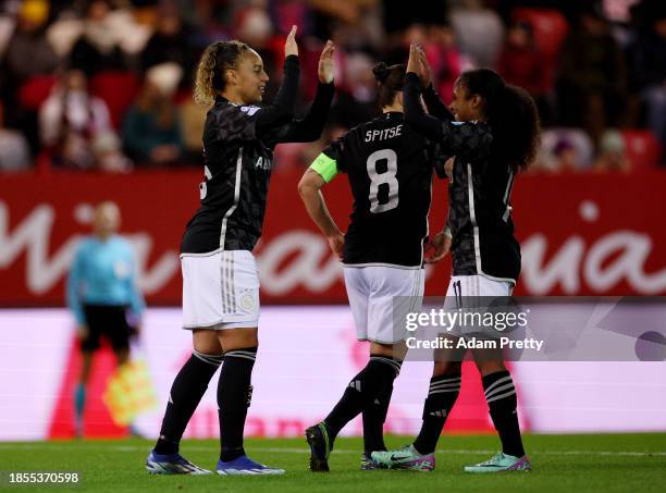 Chasity Grant of Ajax celebrates with with teammates after scoring their team's first goal during the UEFA Women's Champions League group stage match...