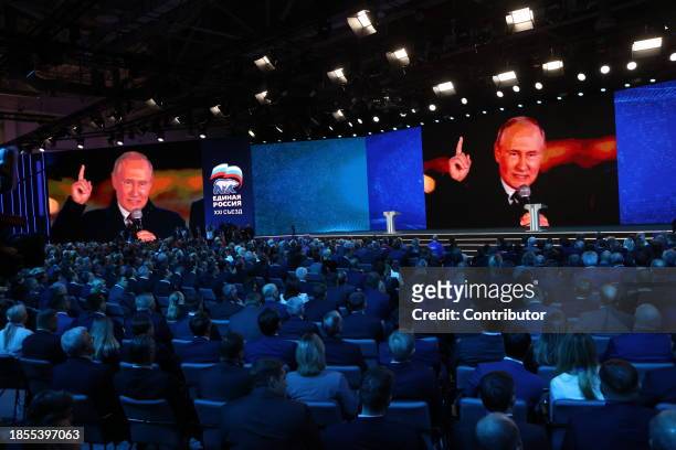 Russian President Vladimir Putin is seen on the screens during the 21th Congress of the United Russia Party on December 17 in Moscow, Russia....